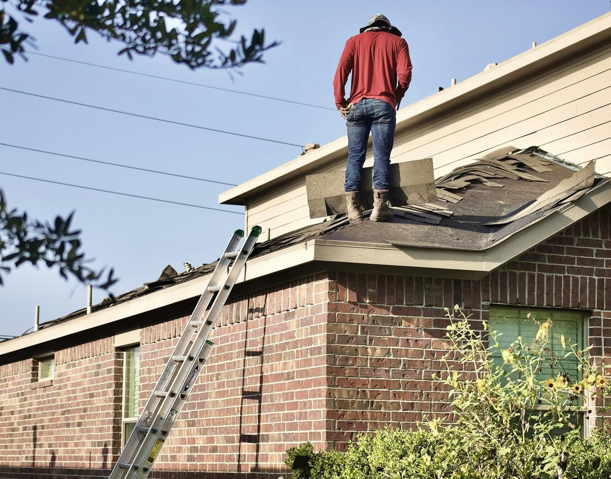 Roofing contractor working on a residential roof